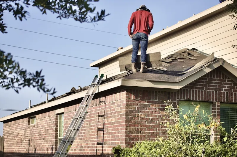 Professional roofer working on a residential roof in Macy